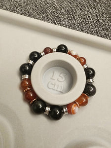 Carnelian: with its fiery orange and red tones, symbolizes motivation, courage, and vitality. It is believed to stimulate creativity, boost confidence, and inspire action. Obsidian: with its lustrous black surface, carries an air of mystery and protection. It is known to absorb negative energy and promote grounding and spiritual growth. Measuring ideally to fit a 15cm wrist, this bracelet is crafted with comfort in mind.